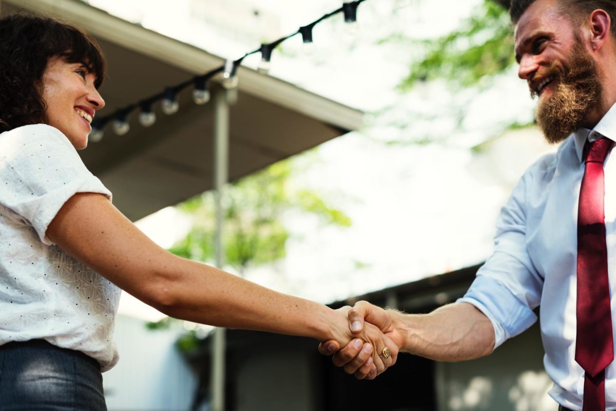 A man and a woman in a business handshake agreement